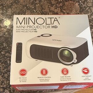 MINOLTA MINI PROJECTOR HD brand new still in box never opened with remote